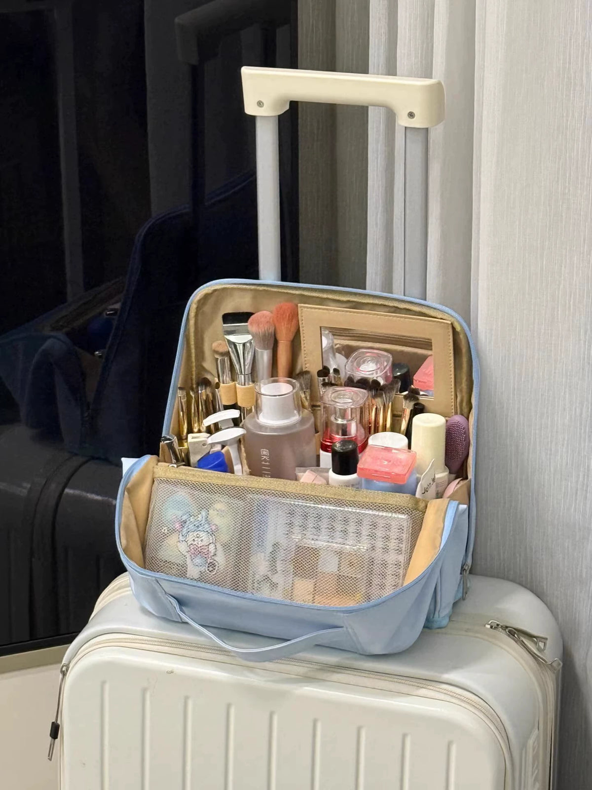 Open light blue makeup organizer with brush holders and divided storage