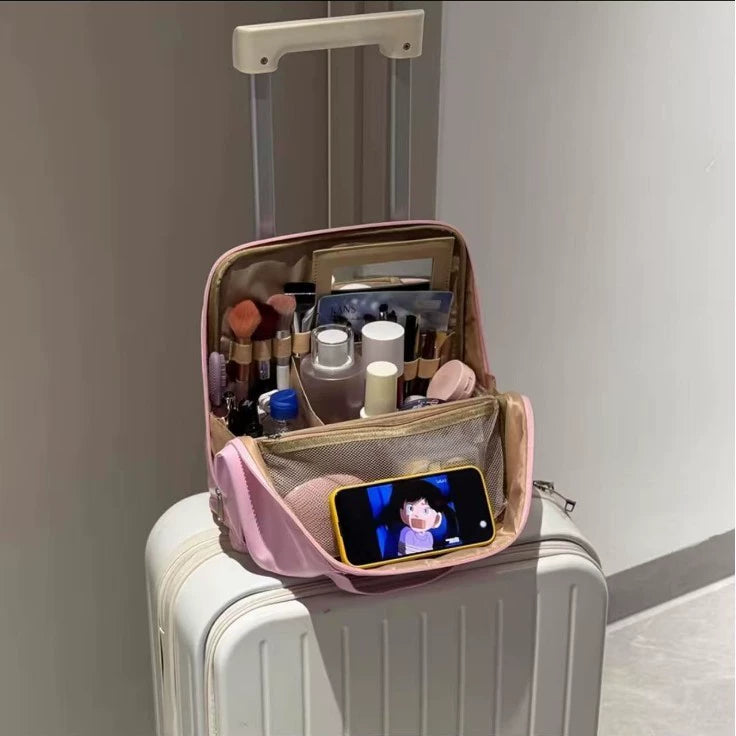 Pink makeup organizer displayed open on luggage
