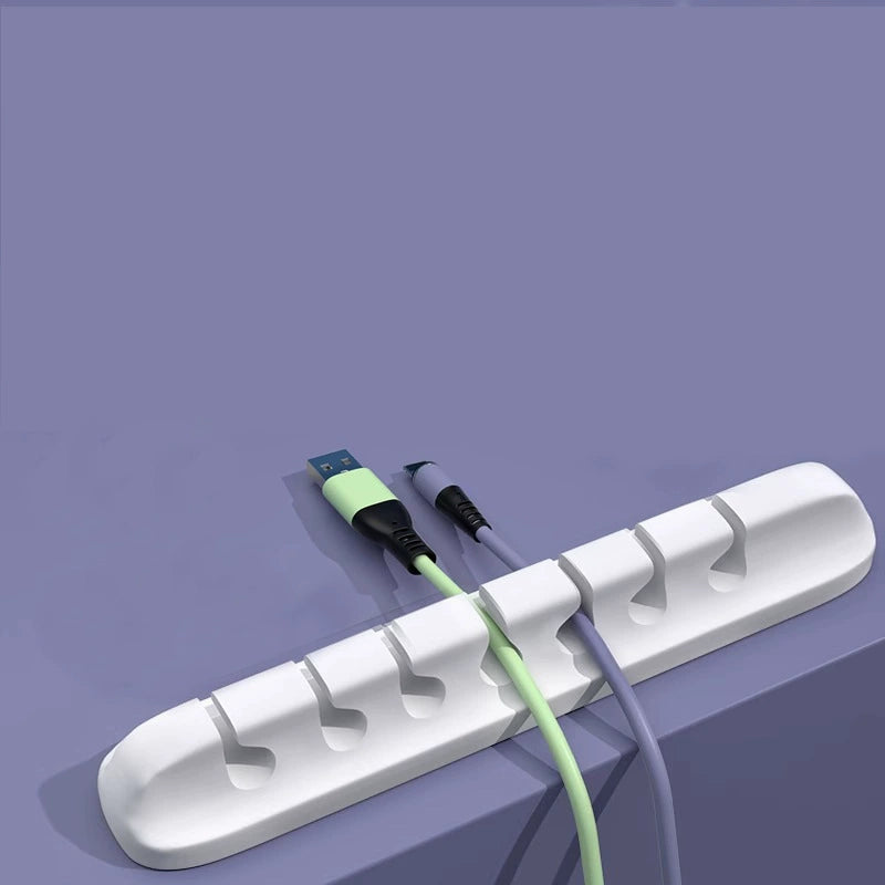 White seven-slot cable organizer holding two cables